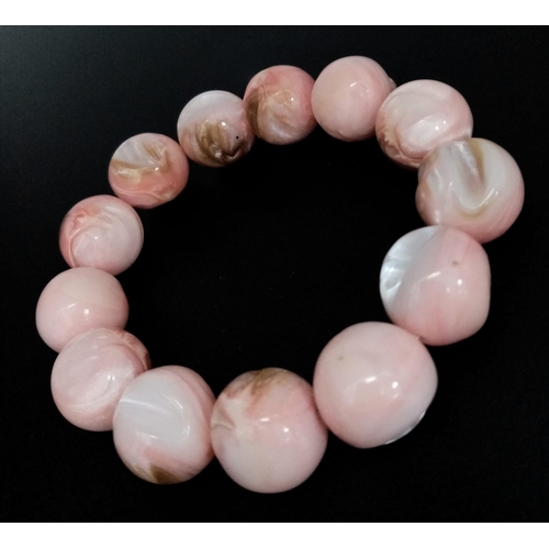 493 - A Purple and a Pink Polished Conch Shell Expandable Bracelet.