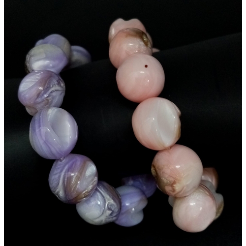 493 - A Purple and a Pink Polished Conch Shell Expandable Bracelet.