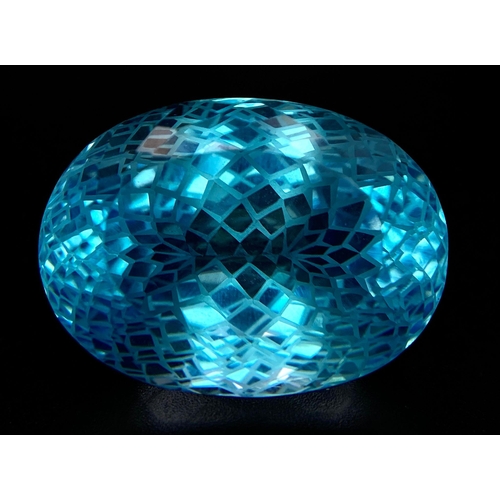 590 - A 92.96ct Blue Topaz Gemstone, in Oval Flower Laser Cut. Comes with the GFCO Swiss Certificate