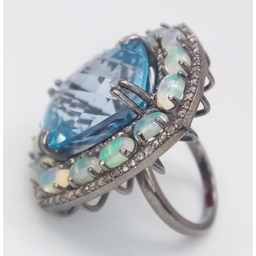 624 - A Mesmerising Blue Topaz, Opal and Diamond Gemstone Ring. Central rectangular blue topaz 20.25ct wit... 