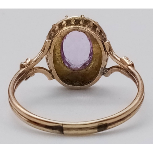 1083 - AN ANTIQUE AMETHYST AND SEED PEARL RING IN 9K GOLD.  2.1gms   size R