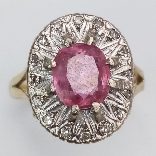 1104 - A NATURAL BURMESE RUBY SURROUNDED BY DIAMONDS AND SET IN 18K GOLD .  6.8gms   size Q