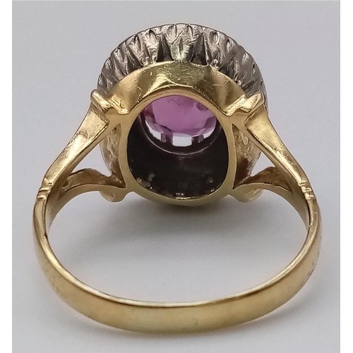 1104 - A NATURAL BURMESE RUBY SURROUNDED BY DIAMONDS AND SET IN 18K GOLD .  6.8gms   size Q