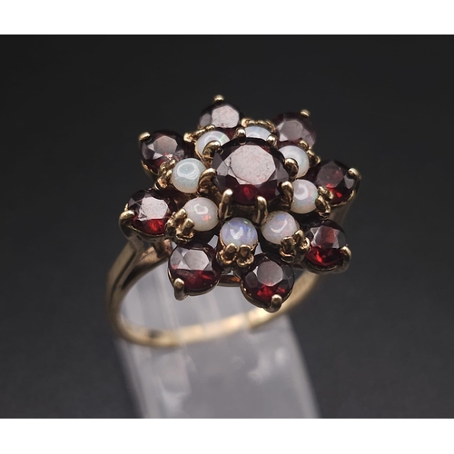 1111 - A 9K GOLD GARNET AND OPAL CLUSTER RING .   5.25gms   size Q