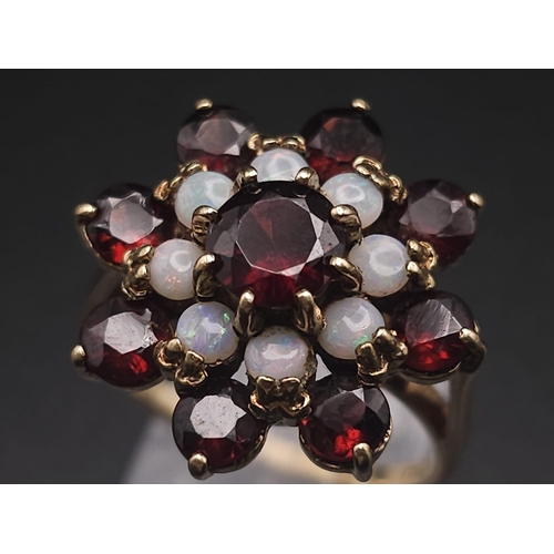 1111 - A 9K GOLD GARNET AND OPAL CLUSTER RING .   5.25gms   size Q