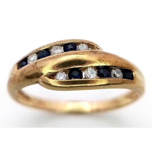 1201 - A 9K YELLOW GOLD DIAMOND & SAPPHIRE TWIST RING. 1.6G. SIZE J