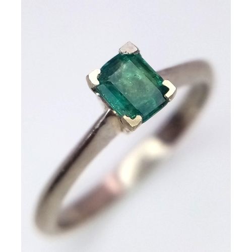 1237 - An 18K White Gold and Emerald Solitaire Ring. Size N. 2.8g total weight.