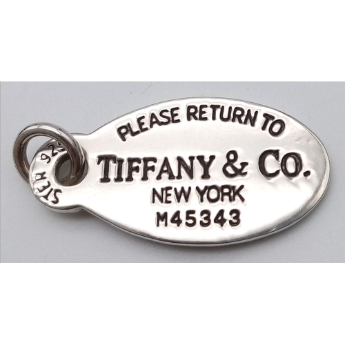 1324 - A STERLING SILVER TIFFANY & CO TAG / PENDANT. 14.2G