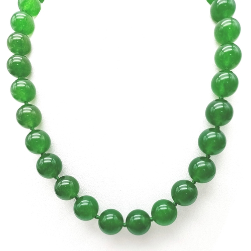 241 - A Green Jade Bead Necklace. 14mm large beads. Gilded clasp. 42cm necklace length.