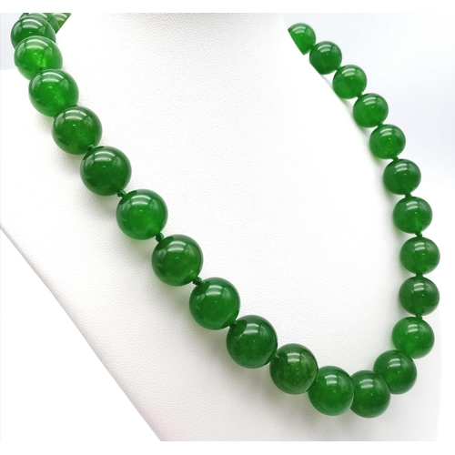 241 - A Green Jade Bead Necklace. 14mm large beads. Gilded clasp. 42cm necklace length.