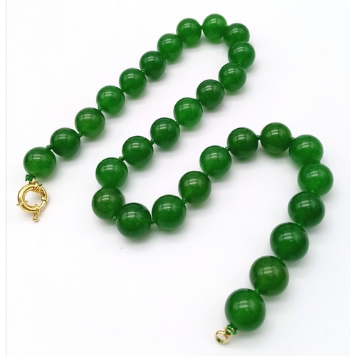 241 - A Green Jade Bead Necklace. 14mm large beads. Gilded clasp. 42cm necklace length.