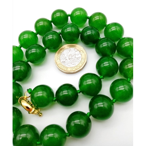 241 - A Green Jade Bead Necklace. 14mm large beads. Gilded clasp. 42cm necklace length.