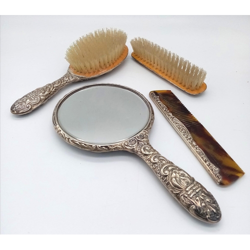 394 - A vintage vanity set consisting of a hair brush, a clothes brush, a comb and a vanity mirror. Beauti... 