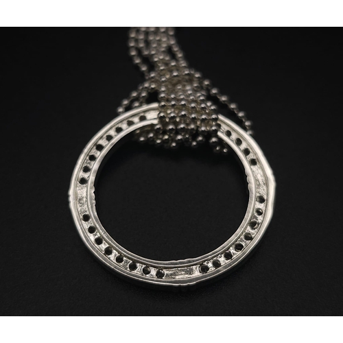 414 - A sterling silver triple chain necklace with a magnifying glass holder pendant decorated with cubic ... 