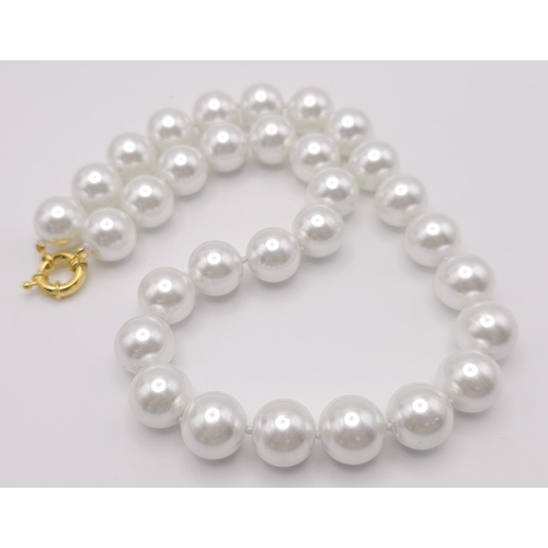 571 - A Large White Bead South Sea Pearl Shell Necklace. 14mm beads. 42cm necklace length.