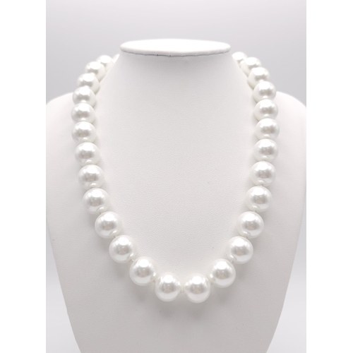 571 - A Large White Bead South Sea Pearl Shell Necklace. 14mm beads. 42cm necklace length.