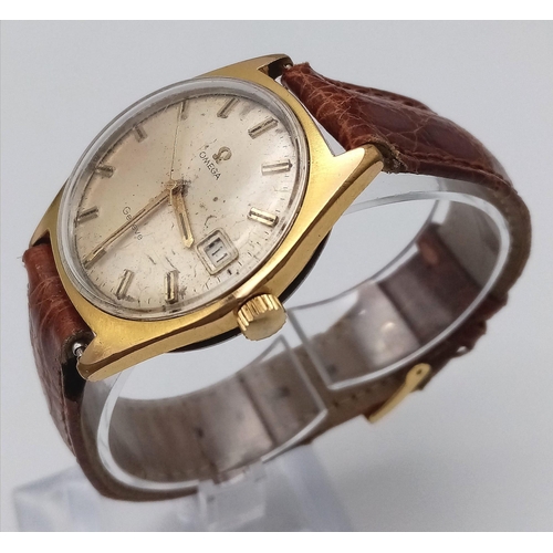 802 - A Vintage Omega Geneve. Brown crocodile strap. Gilded case - 35mm. Gold tone dial with date window a... 