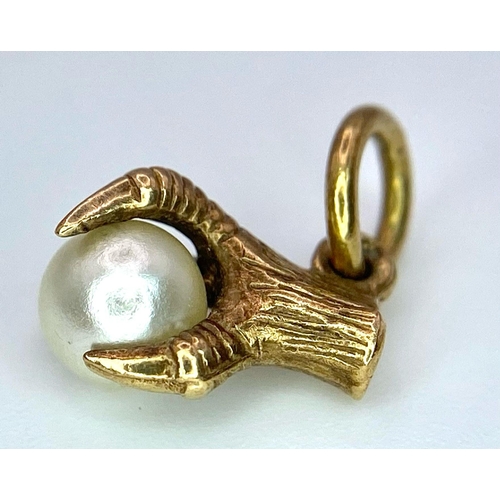 963 - A 9K Yellow Gold, Eagle Claw and Pearl Pendant/charm. 0.91g total weight.