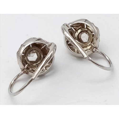 1006 - A Pair of Art Deco Style White Gold and Diamond Stud Earrings. 2.51g total weight.