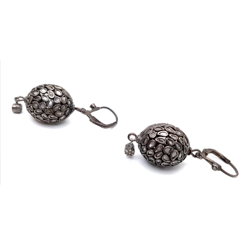 1145 - An Antique Pair of Silver and Rose Cut Diamond Earrings. Two ovoid shapes decorated with multiple di... 