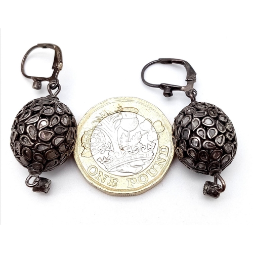 1145 - An Antique Pair of Silver and Rose Cut Diamond Earrings. Two ovoid shapes decorated with multiple di... 