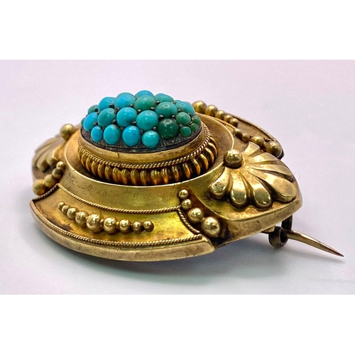 668 - An ornate, Antique Mid-Carat Gold Brooch with Turquoise centre.
Elaborate frame with Art Deco motifs... 