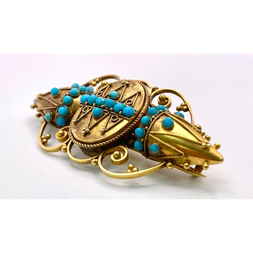 1159 - An Antique, Victorian 15K Gold and Turquoise Brooch. Scrolled and mirrored decoration. 5.5cm. 8.46g ... 