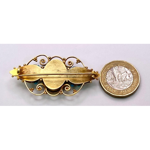 1159 - An Antique, Victorian 15K Gold and Turquoise Brooch. Scrolled and mirrored decoration. 5.5cm. 8.46g ... 