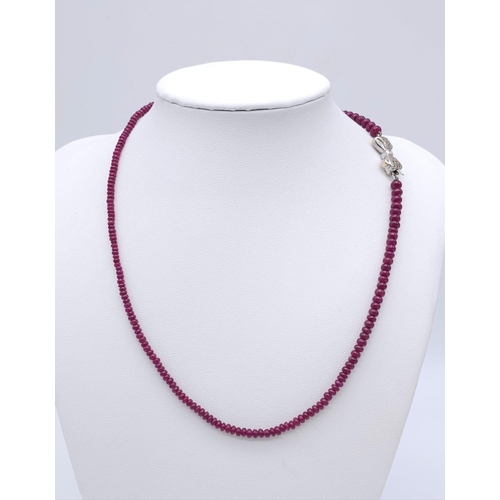 1077 - A superb graduating Ruby Red Stone Beaded Necklace with a 18kt White Gold, Diamond Set Bow Clasp. Me... 