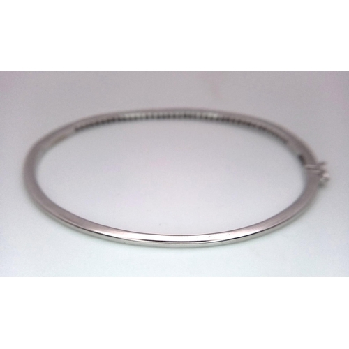 131 - Superb 18kt White Gold, Diamond Set Bangle.
With a safety, hinge release this beautiful bangle measu... 