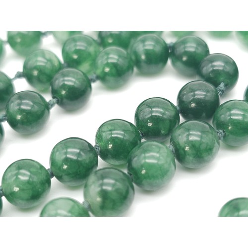 229 - A superb, long beaded Jade necklace.
Measuring 124 cm in length, with rich, deep, mesmerising greens... 