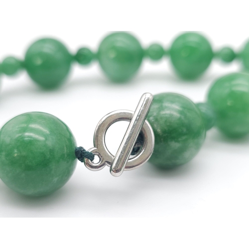 775 - An exquisite large Jade Beaded Necklace.
A mixture of big and small brightly coloured Jade rounded s... 