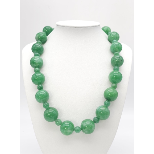 775 - An exquisite large Jade Beaded Necklace.
A mixture of big and small brightly coloured Jade rounded s... 