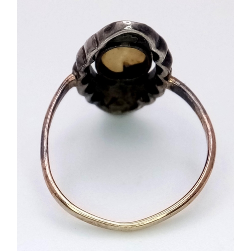 159 - An antique yellow gold ring with an oval Mother of Pearl surrounded by marcasite. Ring size: I, weig... 