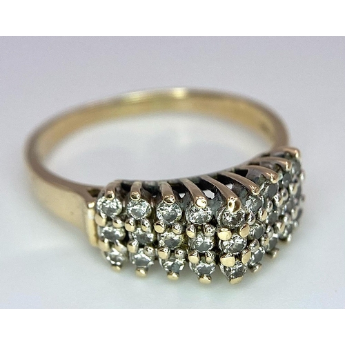 1076 - A 9K YELLOW GOLD 3 ROW DIAMOND RING. 0.50CT. 3G. SIZE O 1/2