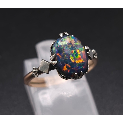 1096 - A VINTAGE BLACK OPAL LIKE GEMSTONE SET IN 9K GOLD . 1.3gms   size O