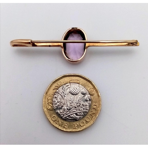 1110 - A 7ct KUNZITE STONE SET IN ANTIQUE ROSE GOLD BAR BROOCH SETTING .4.7gms