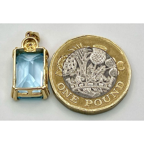 1130 - A 9K GOLD PENDANT WITH AN AQUAMARINE CENTRE STONE .   3.2gms