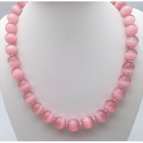 1157 - A Pink Cat's Eye Beaded Necklace. 12mm beads. 42cm necklace length