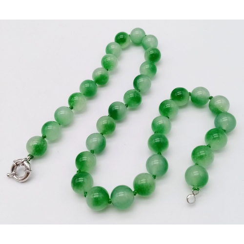 1243 - A Watermelon Jade Bead Necklace. 12mm beads. 42cm necklace length.