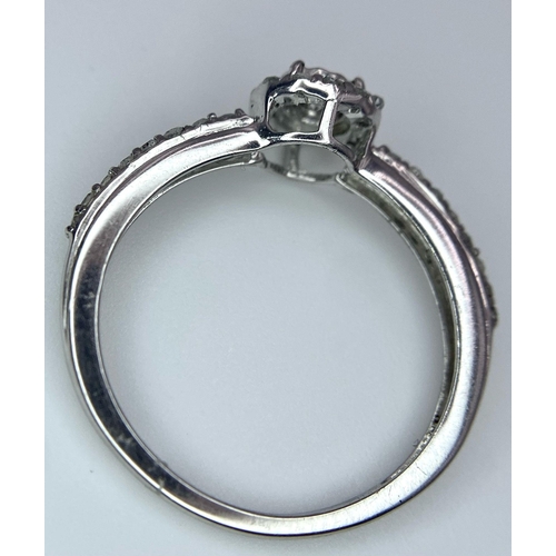 1297 - A 9K WHITE GOLD DIAMOND RING. 1.6G. SIZE L