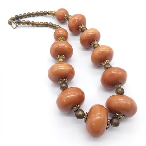 1305 - An Amber Resin Large Rondelle Necklace. 48cm