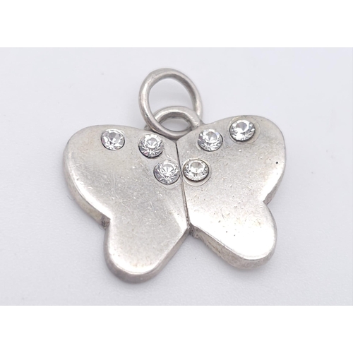 1319 - A STERLING SILVER STONE SET BUTTERFLY PENDANT. 5G