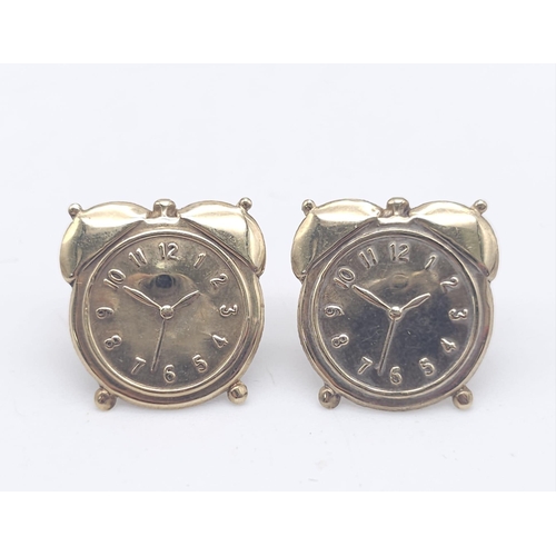 1402 - A PAIR OF 9K YELLOW GOLD ALARM CLOCK STUD EARRINGS. 0.6G