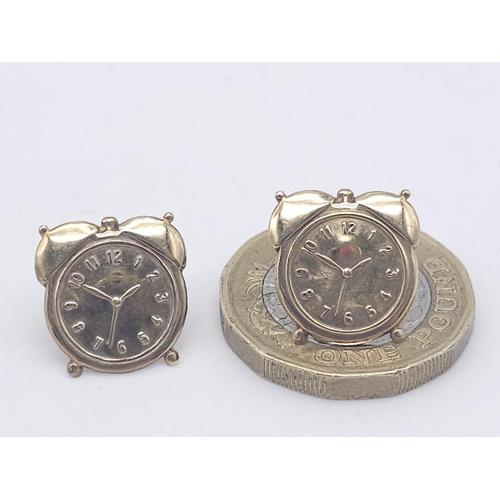 1402 - A PAIR OF 9K YELLOW GOLD ALARM CLOCK STUD EARRINGS. 0.6G