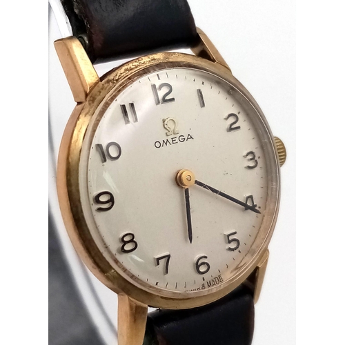 193 - A Vintage 1960s 9K Gold Case Omega Watch. Black leather strap. 9k gold case - 24mm. White dial. Mech... 