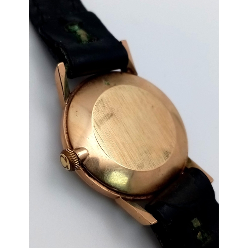 193 - A Vintage 1960s 9K Gold Case Omega Watch. Black leather strap. 9k gold case - 24mm. White dial. Mech... 