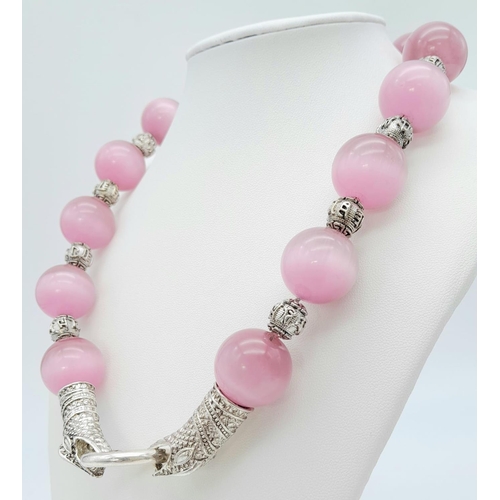 161 - A spectacular, large beaded (18 mm), pink cat’s eyes necklace with a Chinese silver snake clasp and ... 