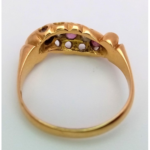 235 - AN ANTIQUE 18K GOLD RING WITH DELICATE SCROLL WORK ENCASING DIAMONDS AND PINK RUBY .  4.4gms   size ... 