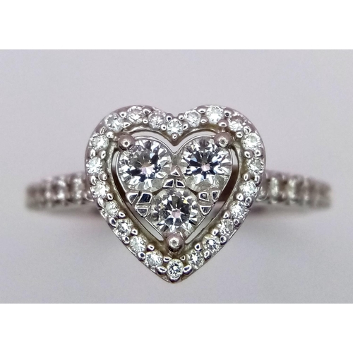 305 - A PLATINUM DIAMOND CLUSTER RING IN THE SHAPE OF A HEART - 0.63CT. 5.3G. SIZE P